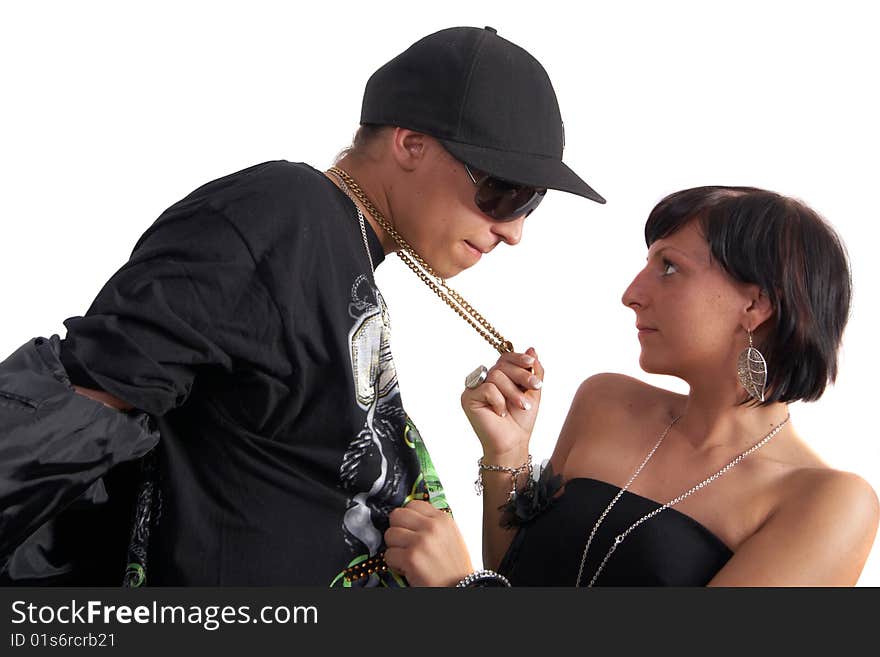 Young couple in love is about to kiss. The woman is pulling the man closer with his necklace. Isolated over white. Young couple in love is about to kiss. The woman is pulling the man closer with his necklace. Isolated over white.