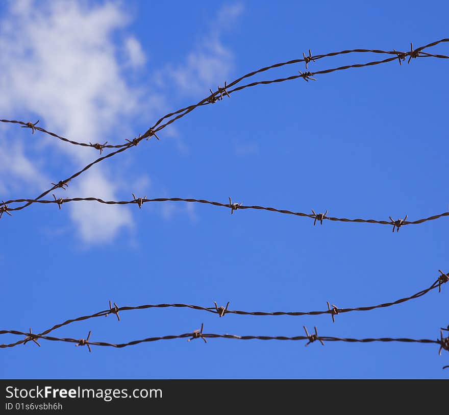 Baber wire against blue sky. Baber wire against blue sky