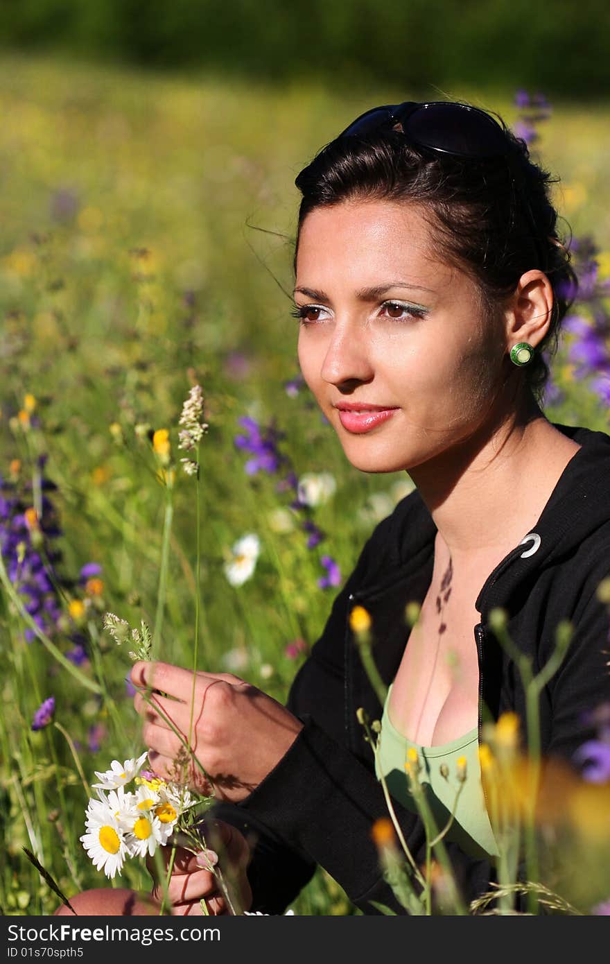 Young Girl In A Field With Flowers