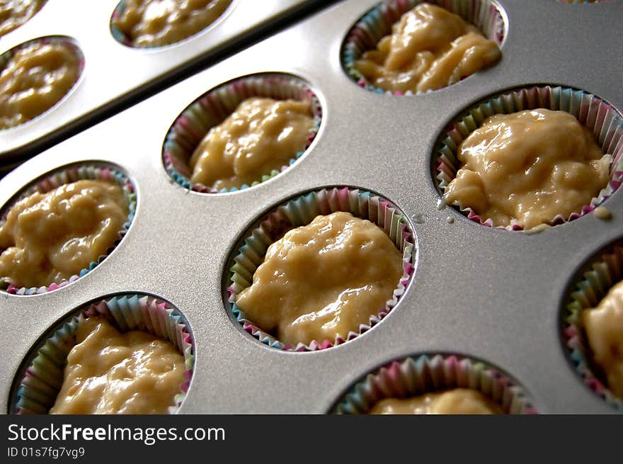 Cupcake batter in a baking pan.