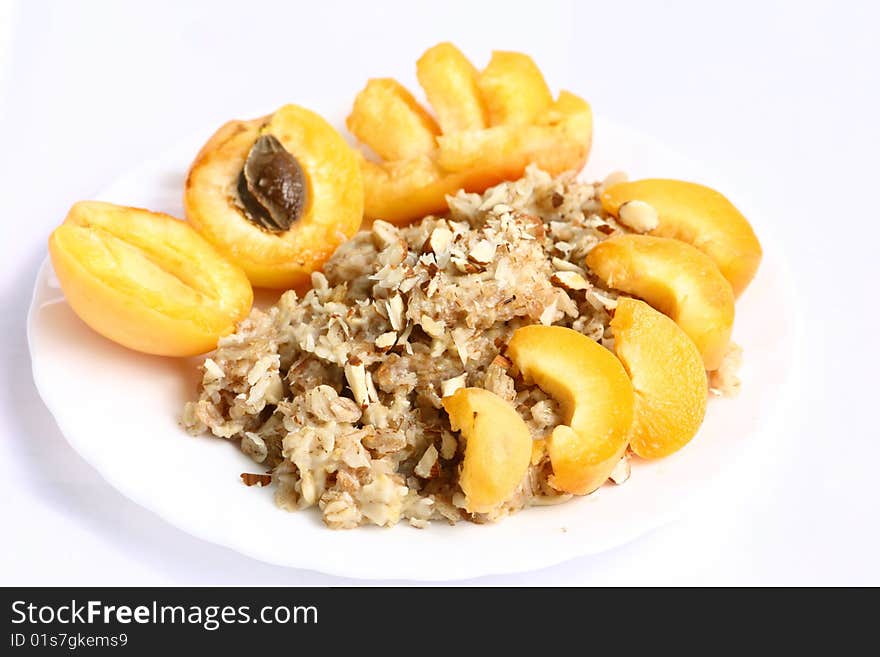 Apricot, porridge and almonds on a plate