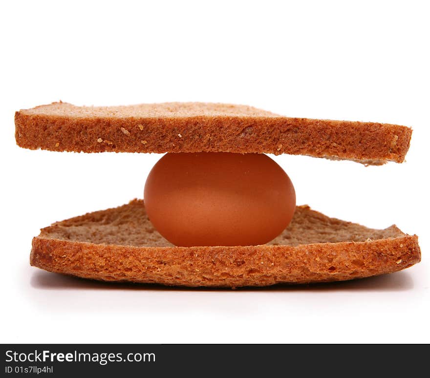 Taken in studio of an egg between two pieces of bread. Taken in studio of an egg between two pieces of bread