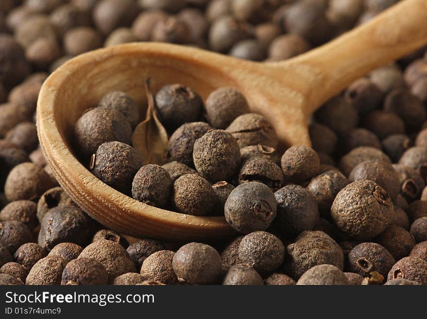 Aromatic pepper in wooden spoon