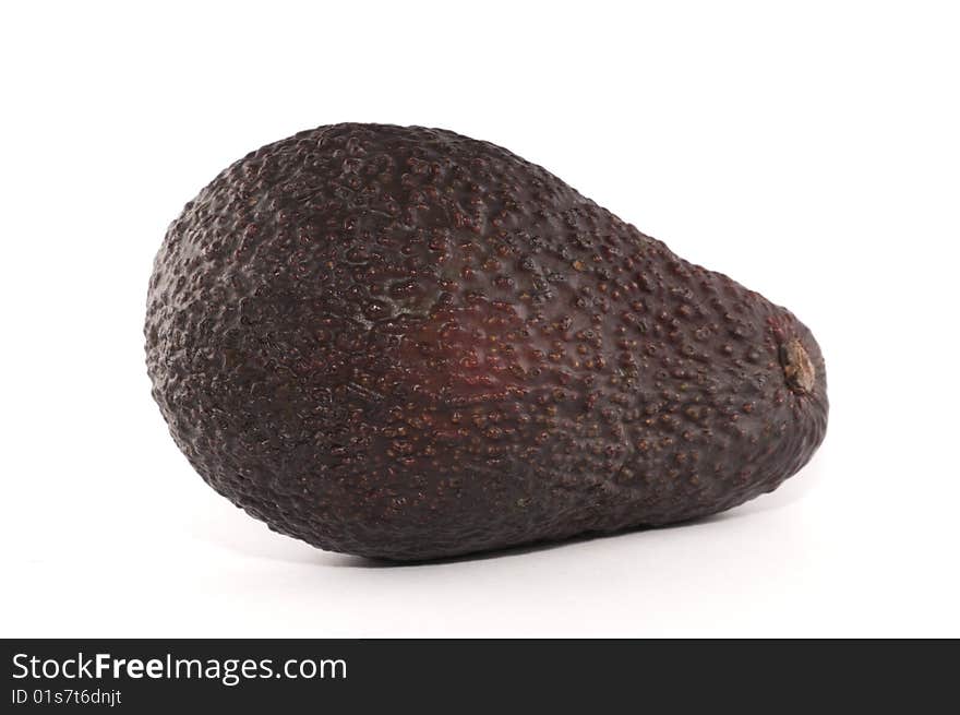 A picture of a single avocado isolated against a white background