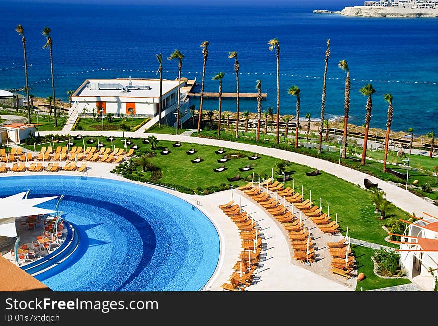 Sunbeds and umbrellas near resort's pool. Sunbeds and umbrellas near resort's pool