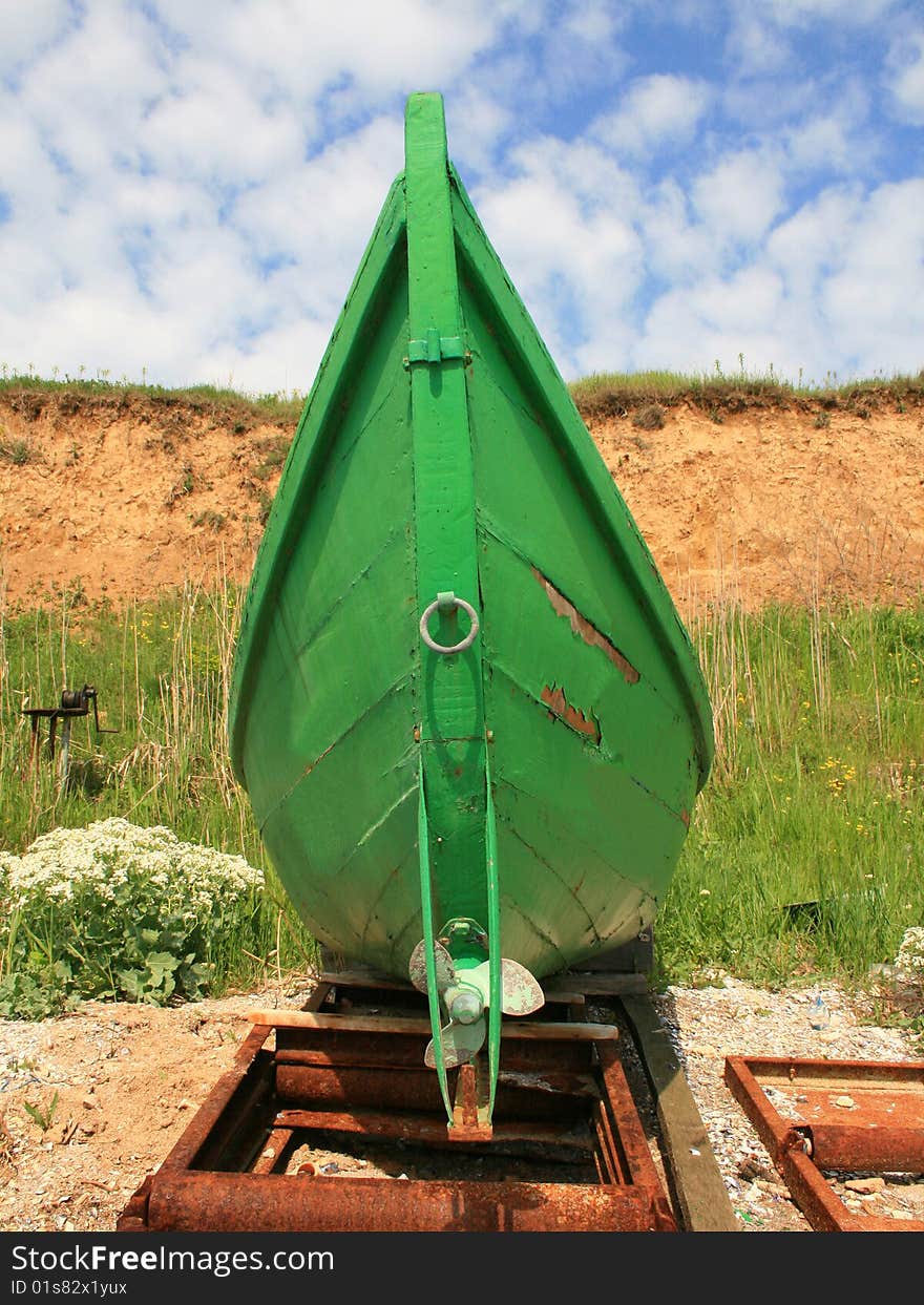 Picture of a green fisher boat on Black sea Shoreline