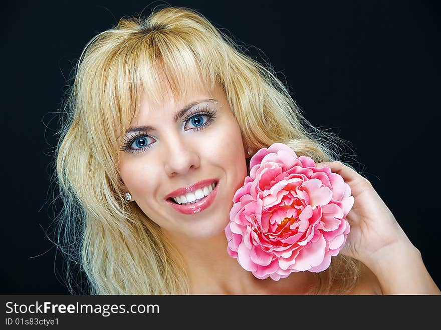 Portrait of young woman with flower on black background. Portrait of young woman with flower on black background