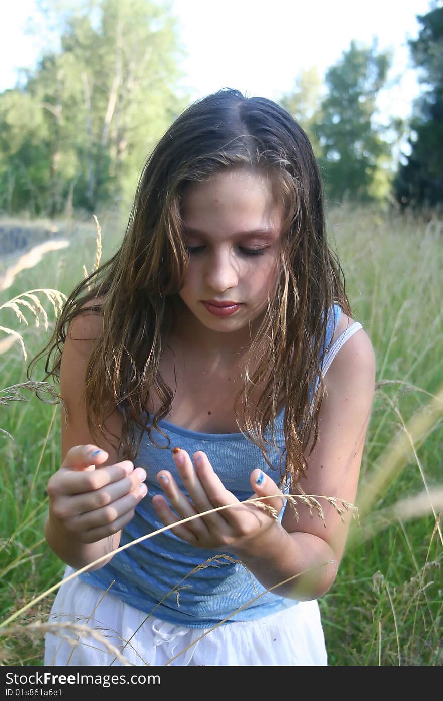 Beautiful young girl with long, brown hair on a summer evening. Beautiful young girl with long, brown hair on a summer evening