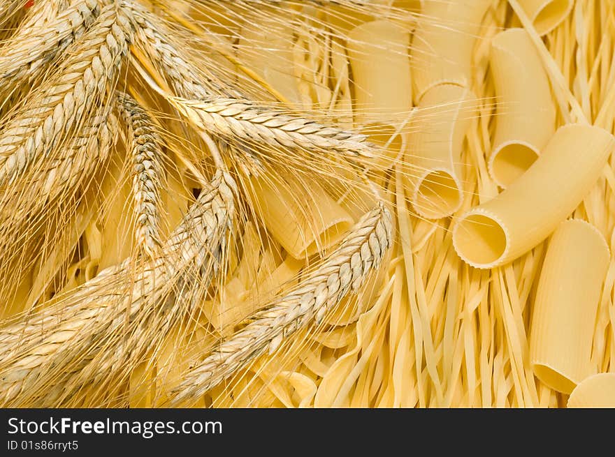 Noodles, macaroni and wheat stalks on a table in the field. Noodles, macaroni and wheat stalks on a table in the field.