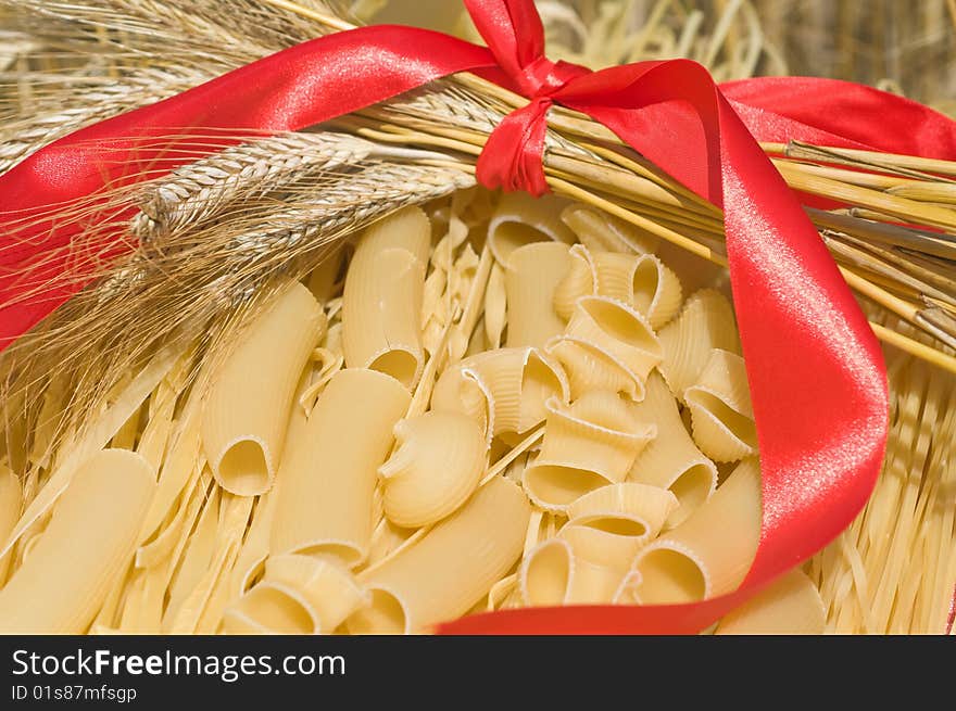 Noodles, macaroni and wheat stalks on a table in the field. Noodles, macaroni and wheat stalks on a table in the field.