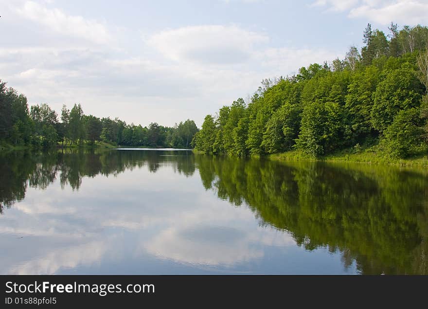 Picturesque landscape spring river and bright trees and bushes, against the backdrop of skies. Picturesque landscape spring river and bright trees and bushes, against the backdrop of skies.