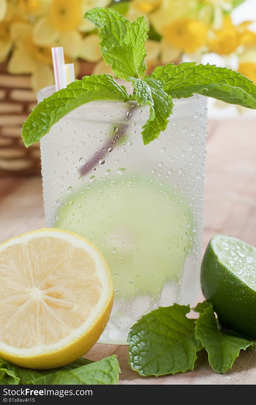 Close up shot of ice cold drink with lime and lemon