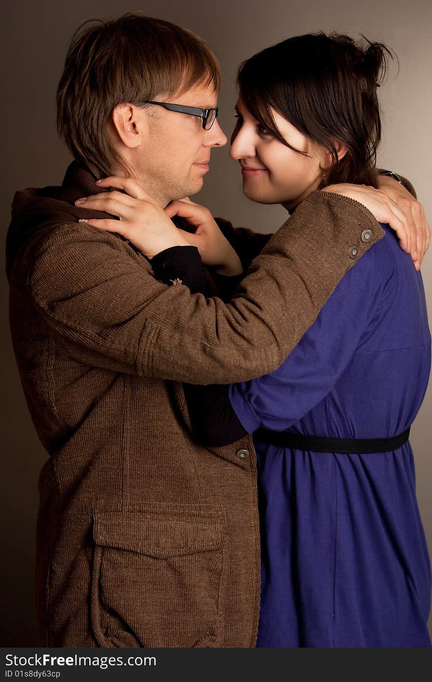 Couple standing together with smile isolated over gray