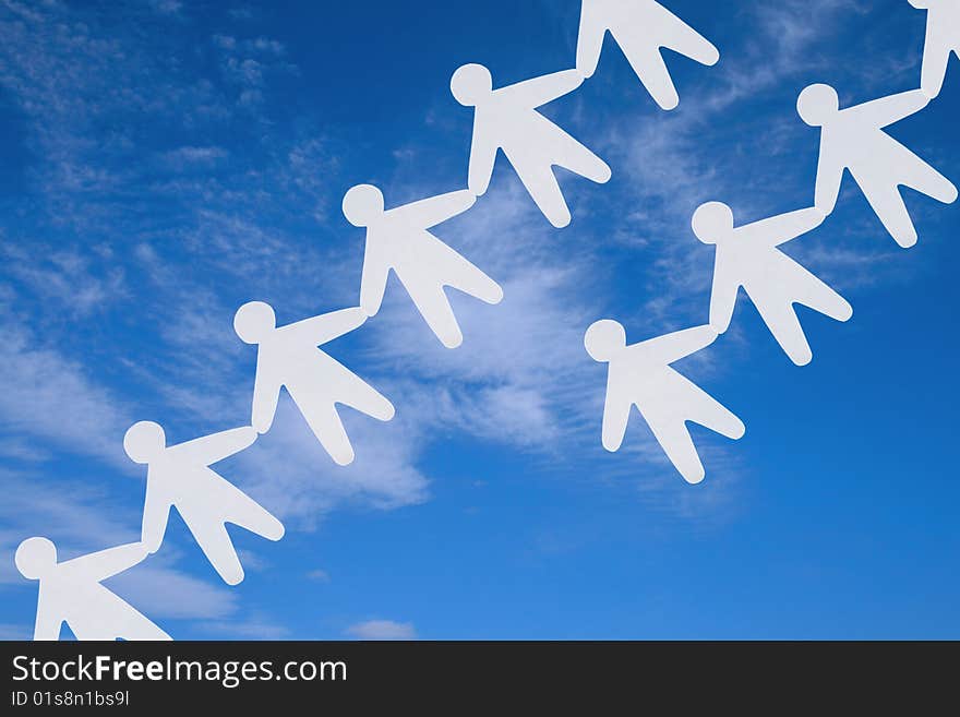 The image of silhouettes of the people keeping for hands on a background of the sky. The image of silhouettes of the people keeping for hands on a background of the sky.