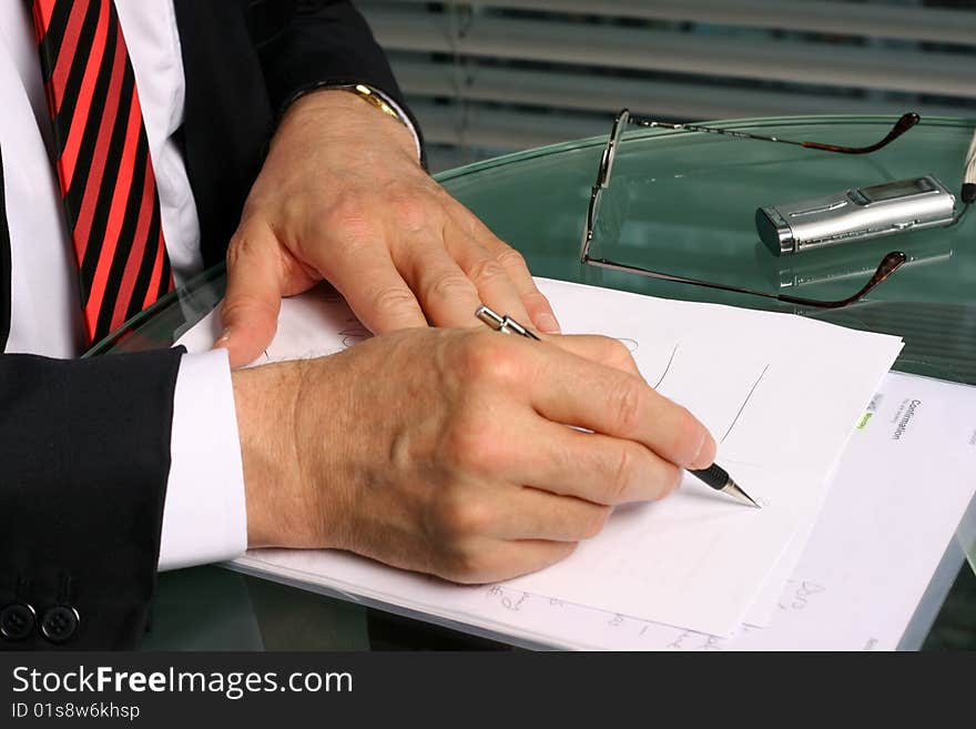 Businessman taking notes with pencil