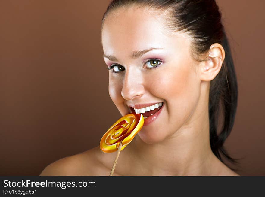 Beauty portrait of a young woman with a lollipop. Beauty portrait of a young woman with a lollipop