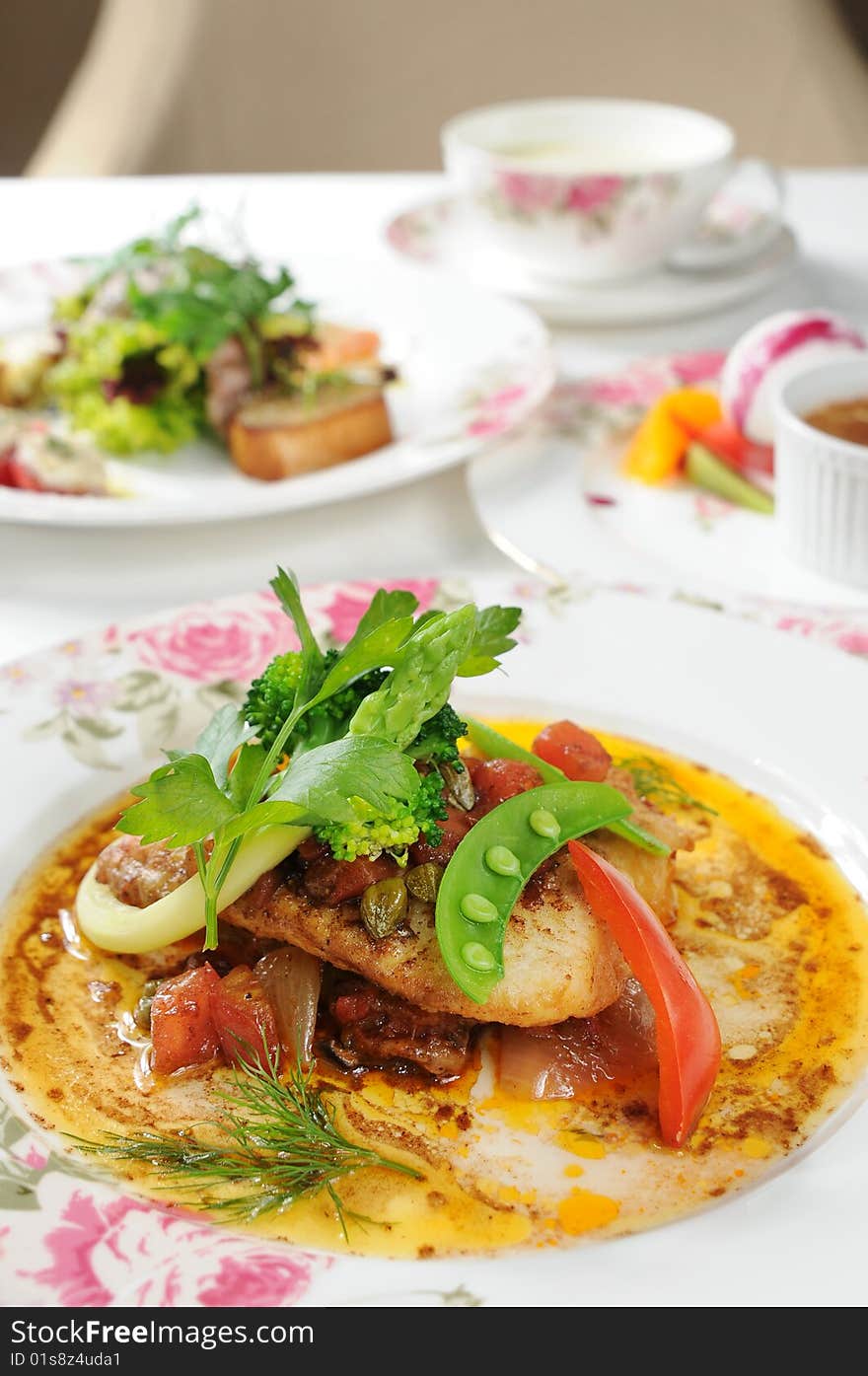 A fish restaurant row on white dish. A fish restaurant row on white dish