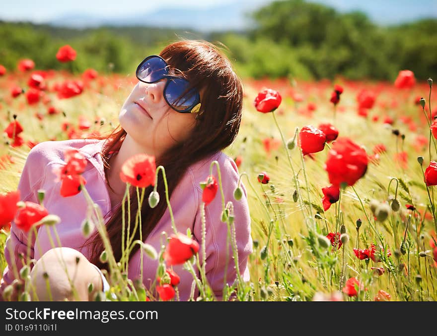 Pretty young girl in sunglasses with red flowers. Pretty young girl in sunglasses with red flowers