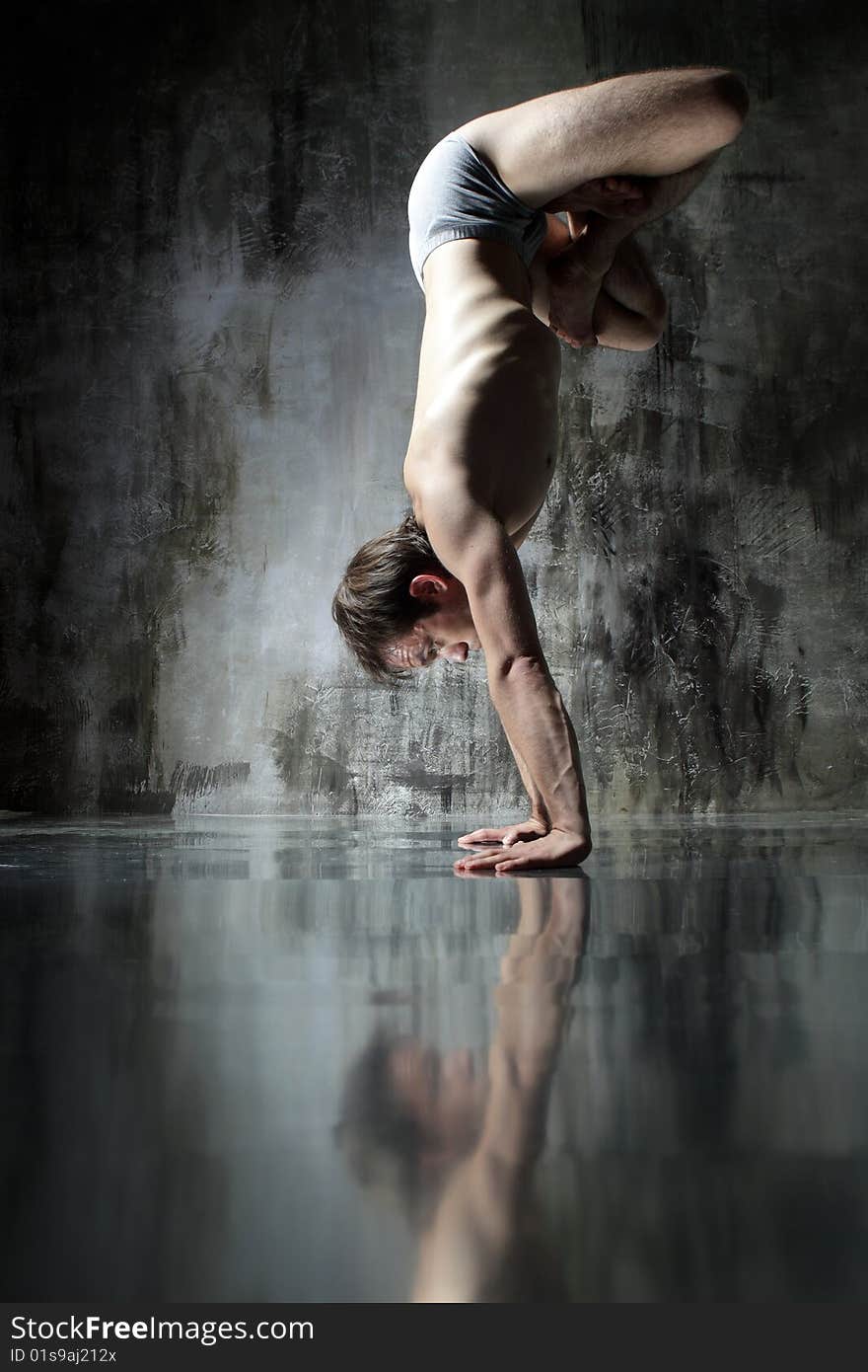 Cool yoga man posing on dirty grunge background. Cool yoga man posing on dirty grunge background