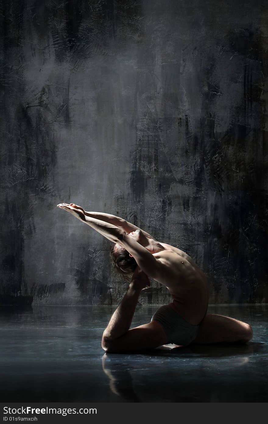 Cool yoga man posing on dirty grunge background. Cool yoga man posing on dirty grunge background