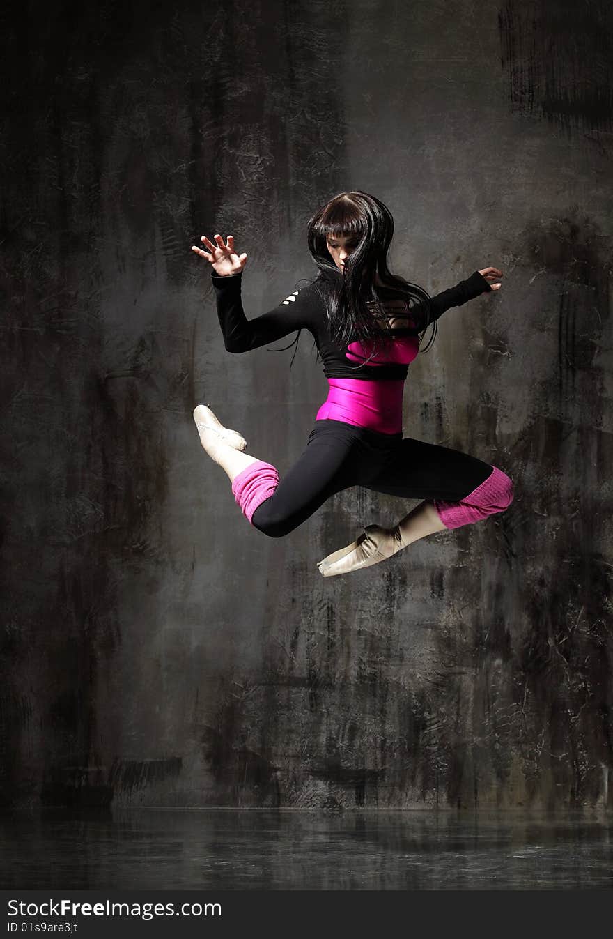 Modern style dancer posing on dirty grunge background. Modern style dancer posing on dirty grunge background