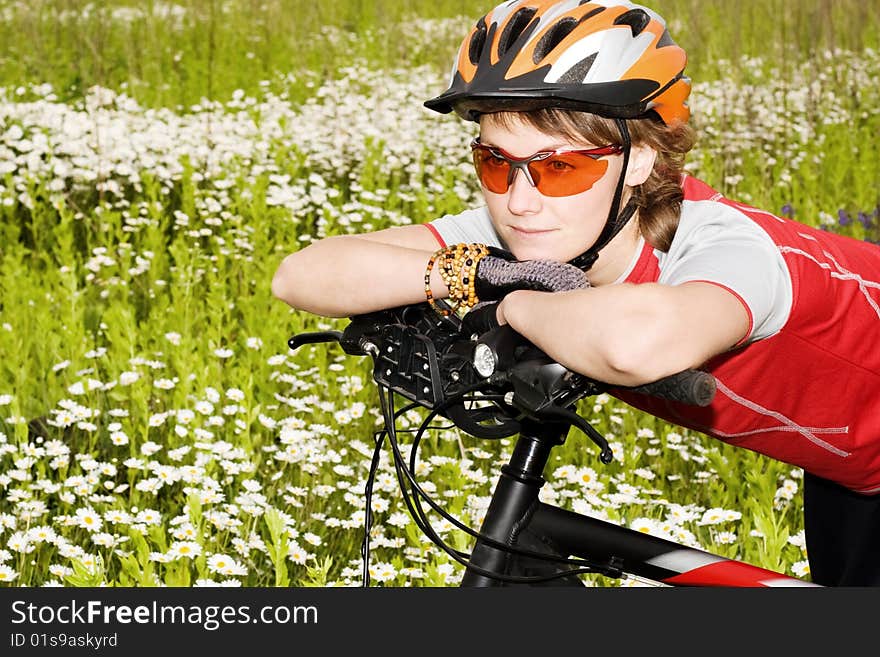 An image of girl and bicycle in the field. An image of girl and bicycle in the field