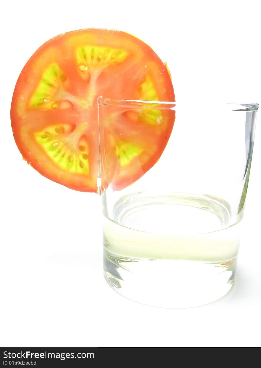 Glass of sunflower oil and tomatoesfast food, white background. Glass of sunflower oil and tomatoesfast food, white background.