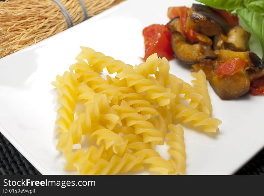 Italian pasta with aubergines, tomatoes and basil. Italian pasta with aubergines, tomatoes and basil