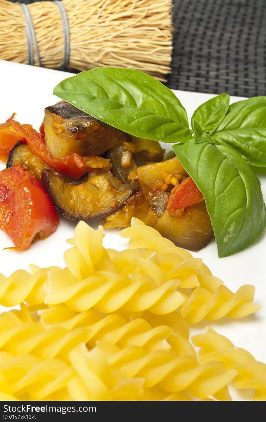 Italian pasta with aubergines, tomatoes and basil. Italian pasta with aubergines, tomatoes and basil