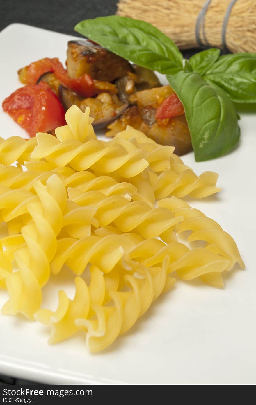 Italian pasta with aubergines, tomatoes and basil. Italian pasta with aubergines, tomatoes and basil