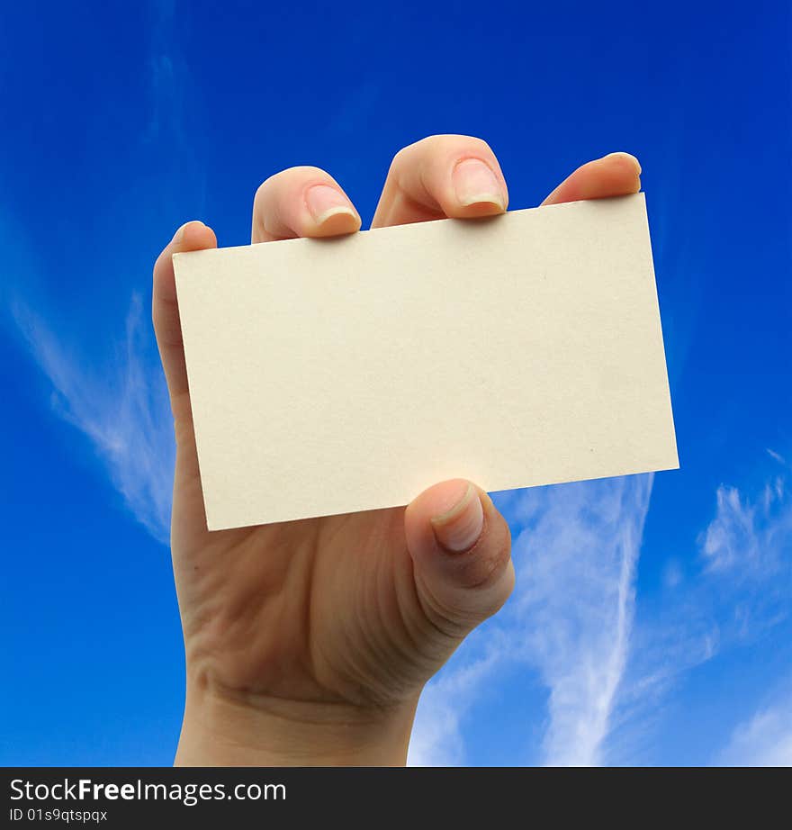 Card blank in a hand on the sky backgraunds