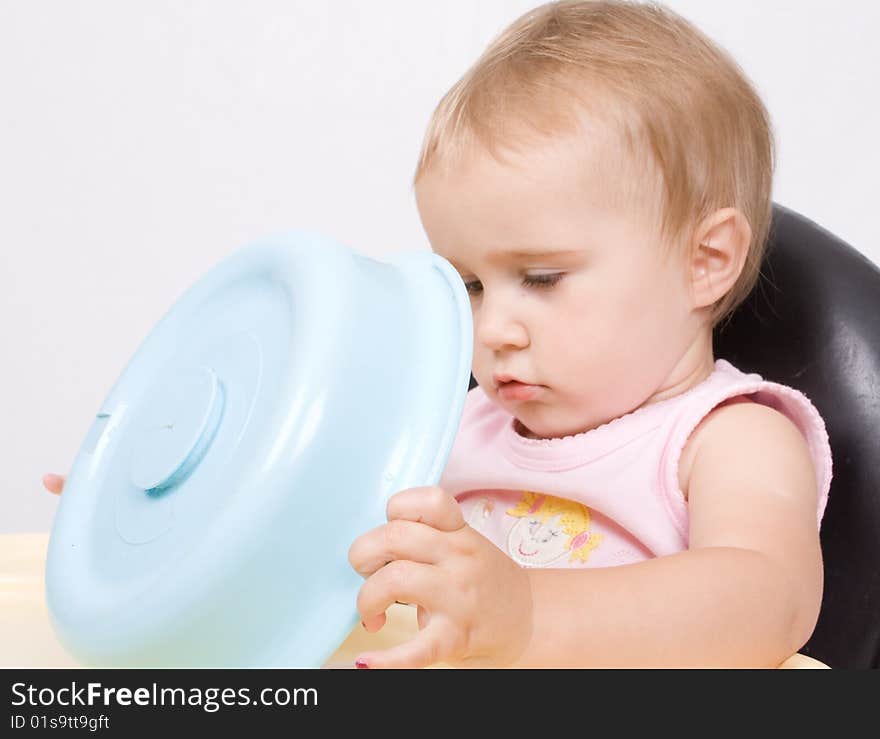 Lttle baby sitting and playing with her toy