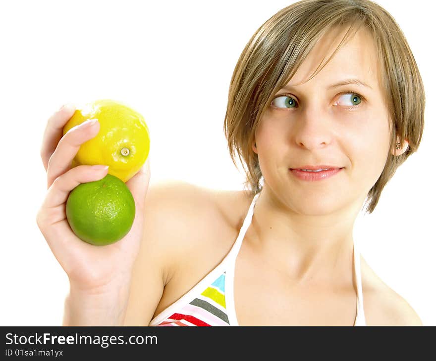 Portrait of a cute young Caucasian blond lady with a nice colorful striped summer dress who is smiling and she is holding a fresh lemon and a lime in her hand. Isolated on white. Portrait of a cute young Caucasian blond lady with a nice colorful striped summer dress who is smiling and she is holding a fresh lemon and a lime in her hand. Isolated on white.