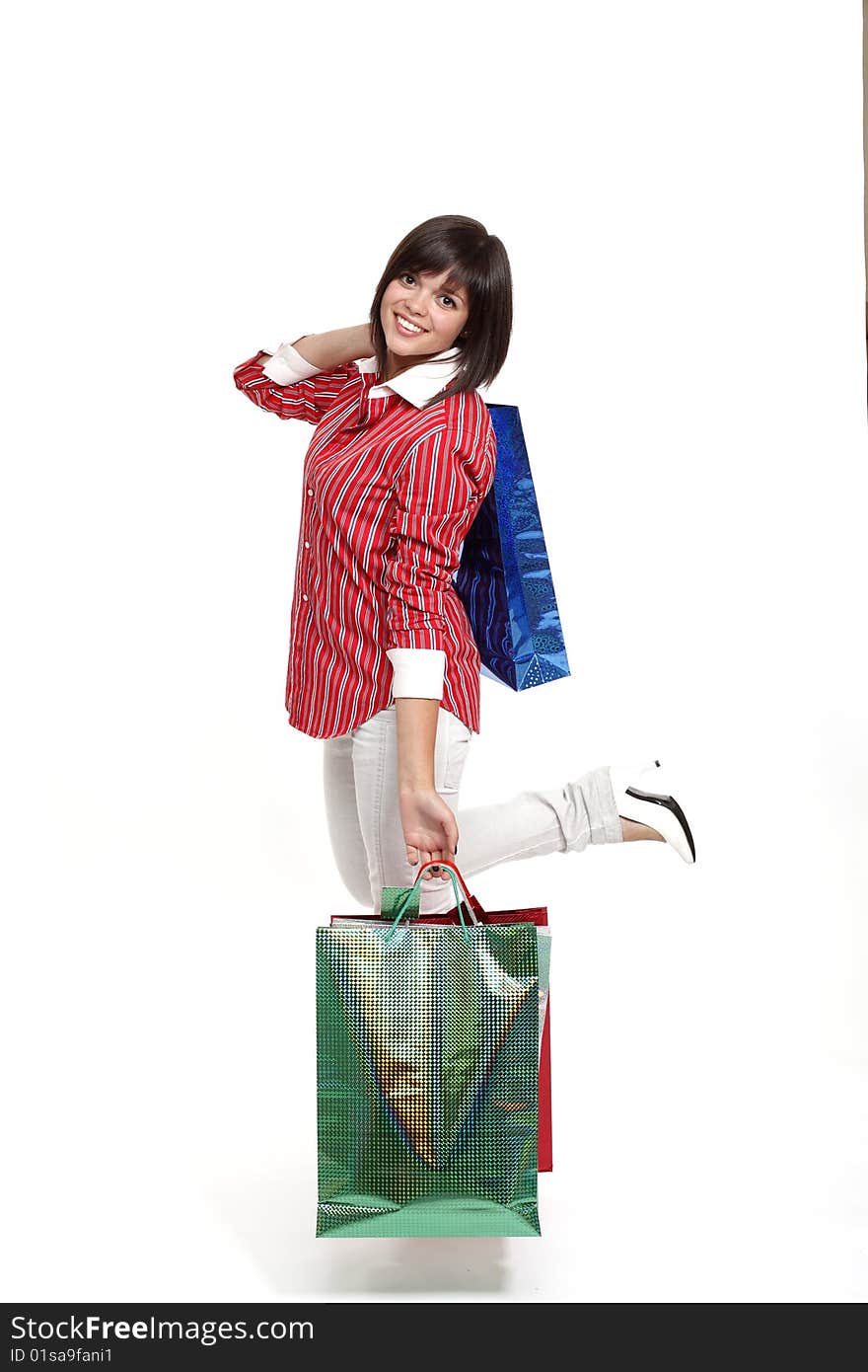 Joyful girl with purchases on a white background. Joyful girl with purchases on a white background