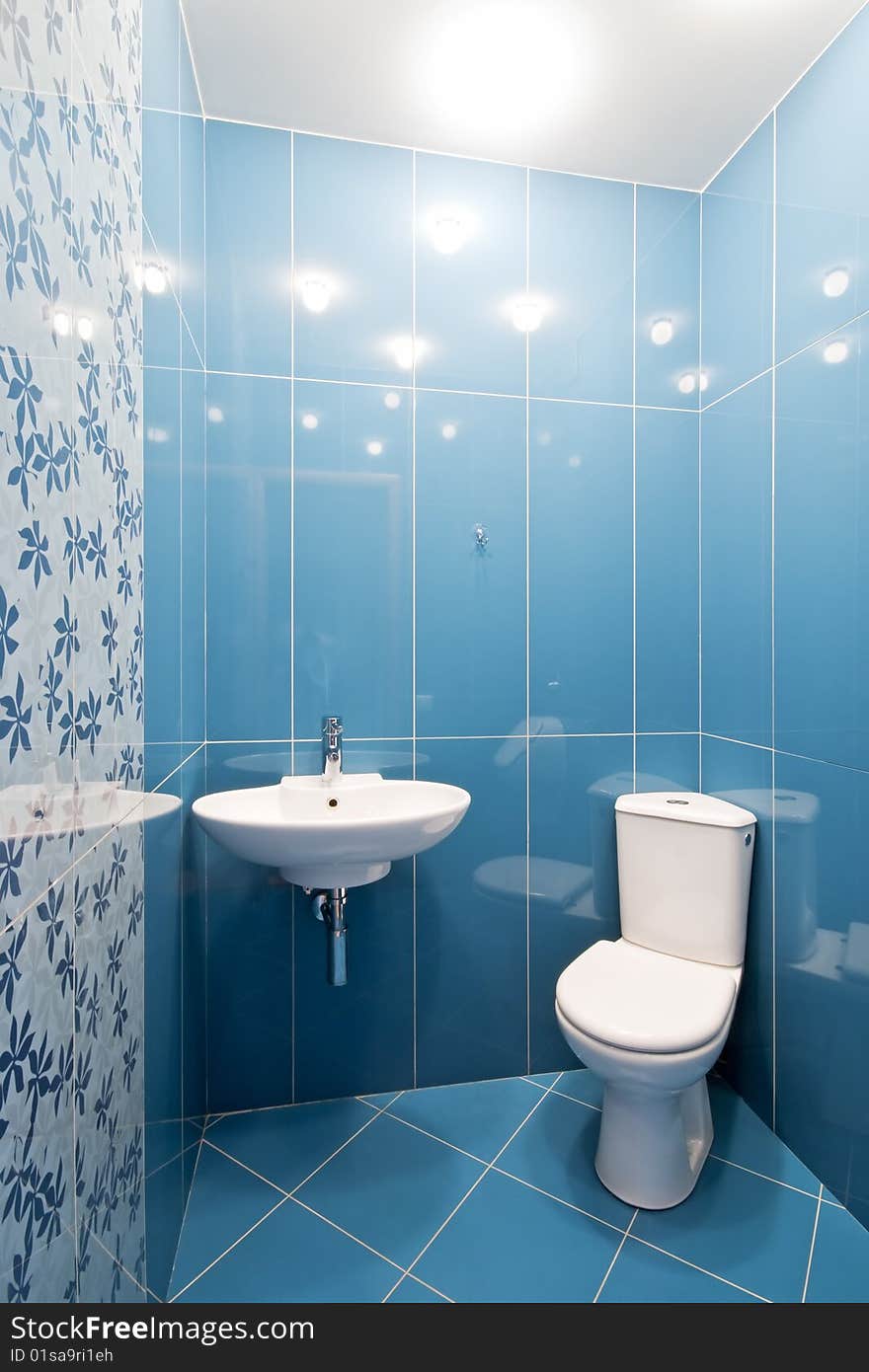 Interior of a new toilet room in blue colors