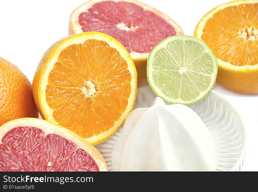 Juicer with slices of grapefruit, orange and lime.