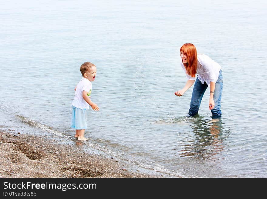 Mother and son playing on beach. Mother and son playing on beach