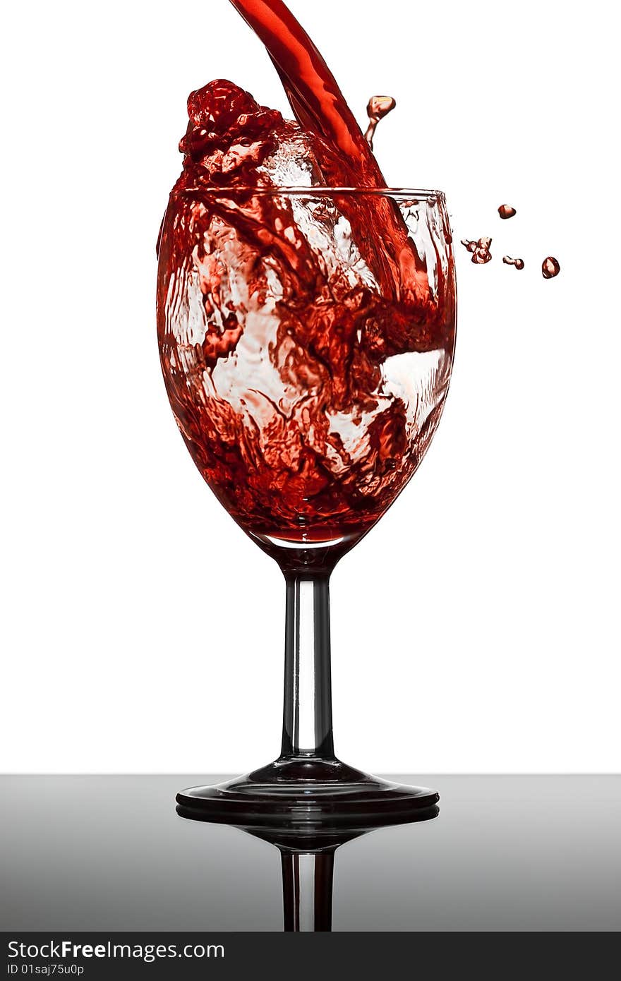 Wine splash in glass with white background