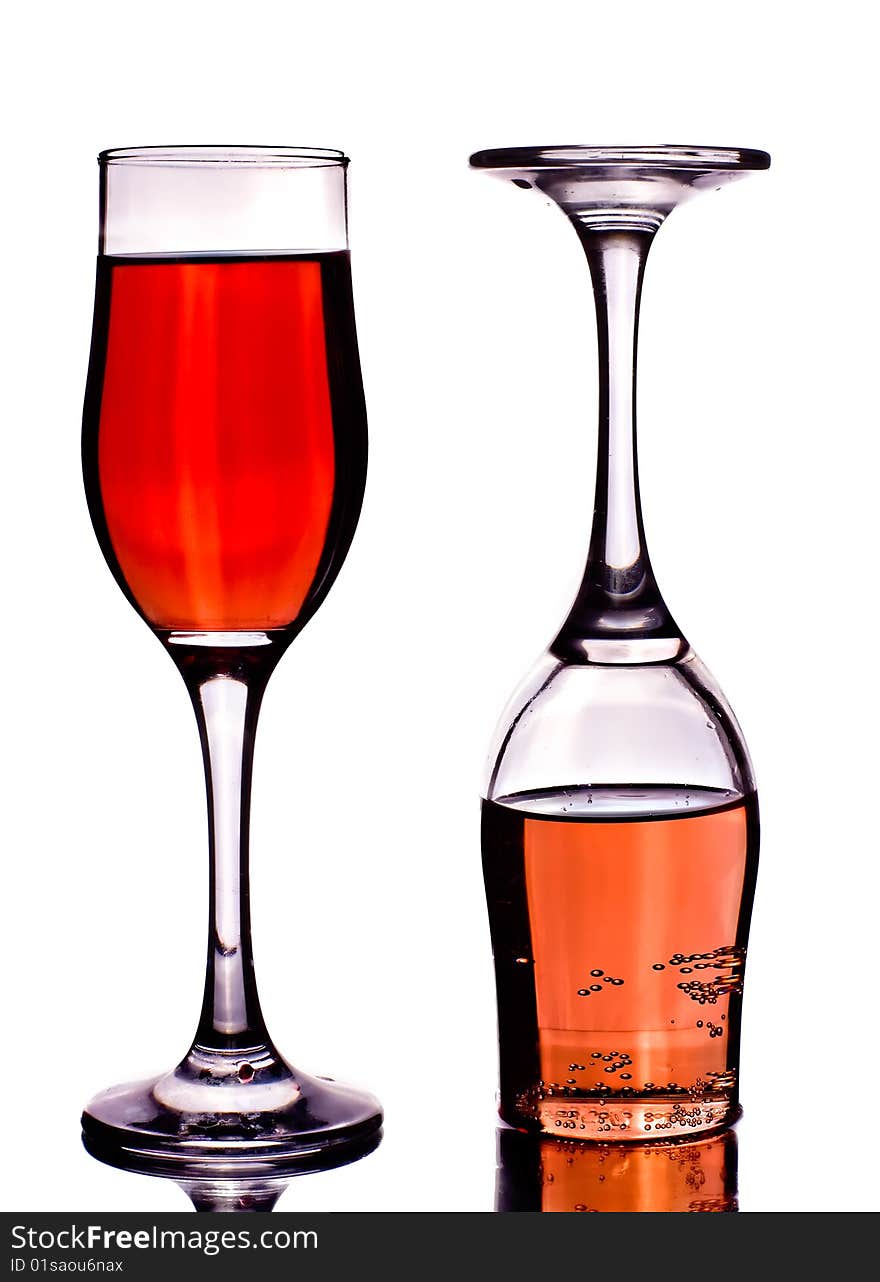 Two glasses with wine on a white background with reflexio