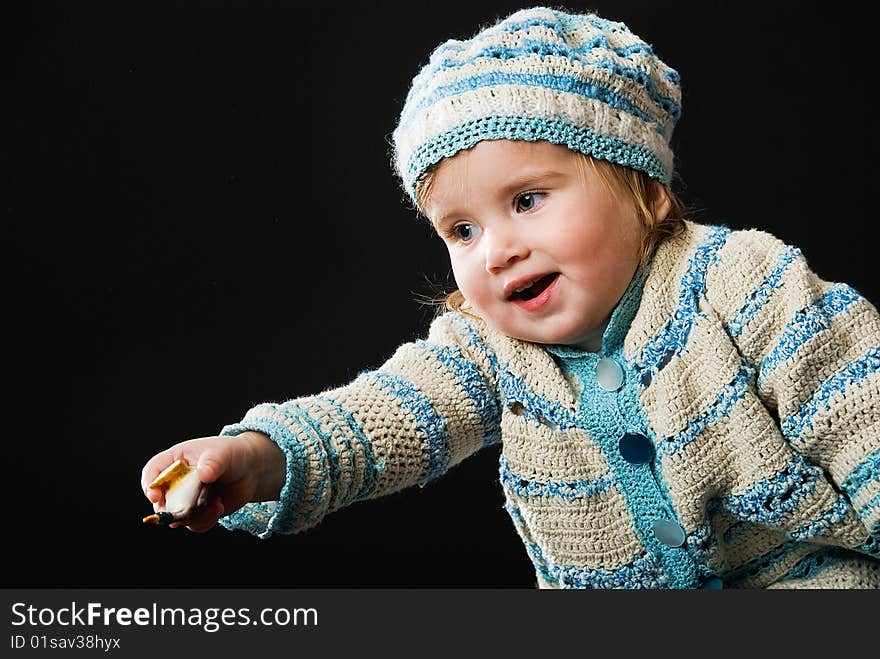 Smiling little baby in a bound suit on black background. Smiling little baby in a bound suit on black background