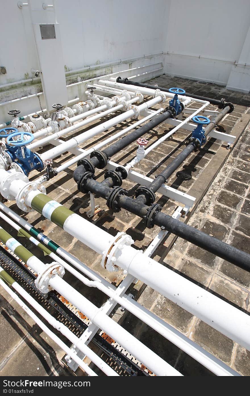 Assorted pipelines on the concrete roof of a building. Assorted pipelines on the concrete roof of a building.