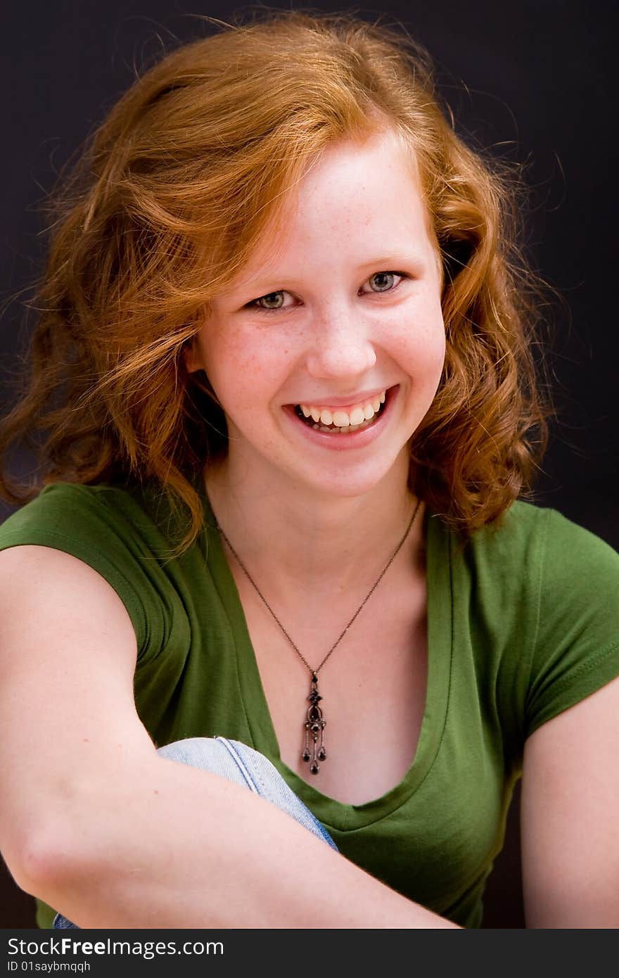 Beautiful freckled teen girl smiling with red hair