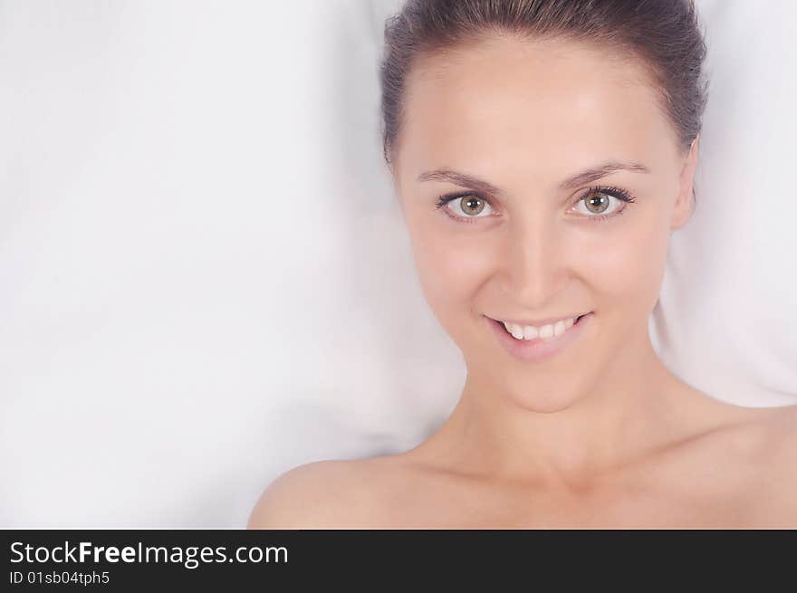 The playful beautiful girl on a white background