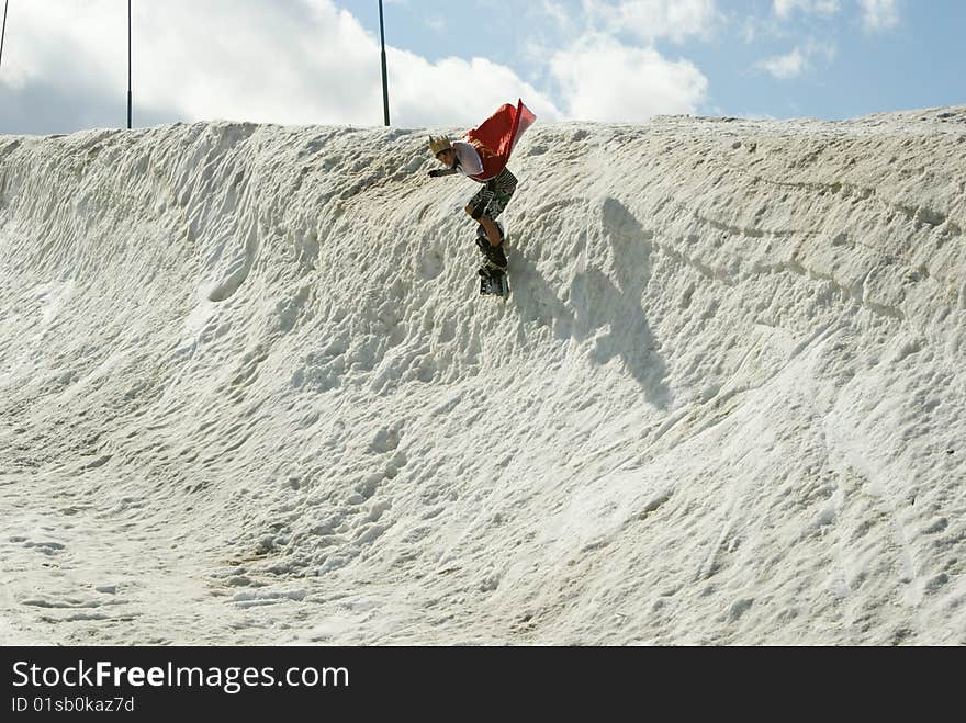 Young boy on the snowboard ski on the half-pipe. Young boy on the snowboard ski on the half-pipe