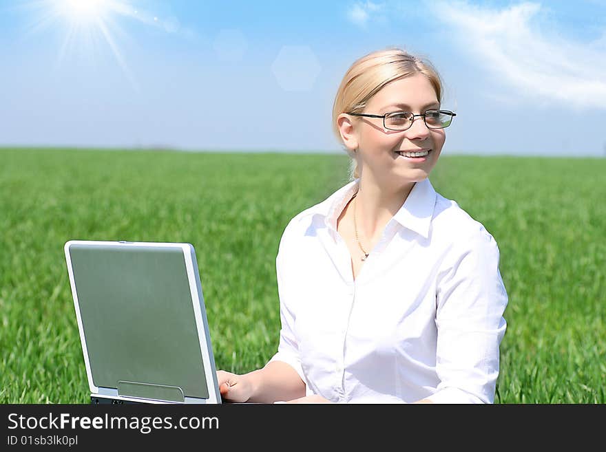 Business lady typing on laptop, sitting outdoors. Business lady typing on laptop, sitting outdoors.