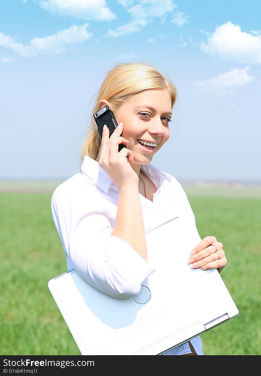 Picture of happy businesswoman with laptop computer, talks by phone