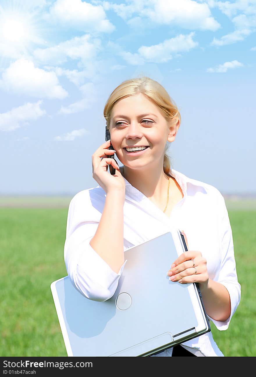 Picture of happy businesswoman with laptop computer, talks by phone