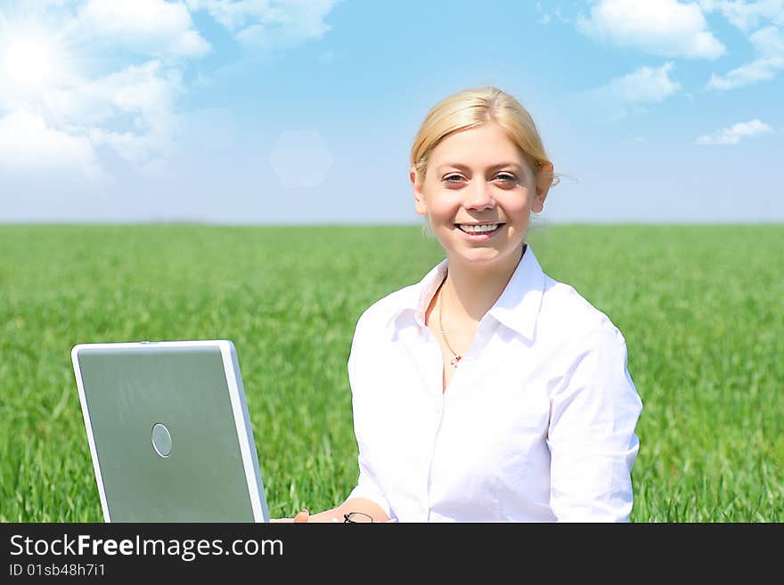 Business lady typing on laptop, sitting outdoors. Business lady typing on laptop, sitting outdoors.