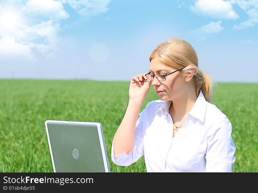 Business lady typing on laptop, sitting outdoors. Business lady typing on laptop, sitting outdoors.