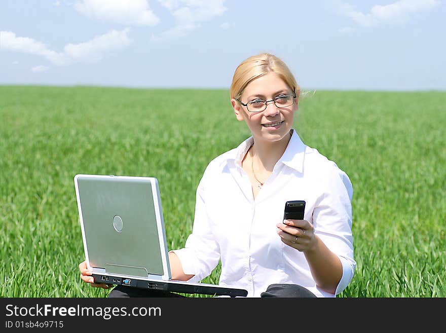 Business lady typing on laptop, sitting outdoors. Business lady typing on laptop, sitting outdoors.